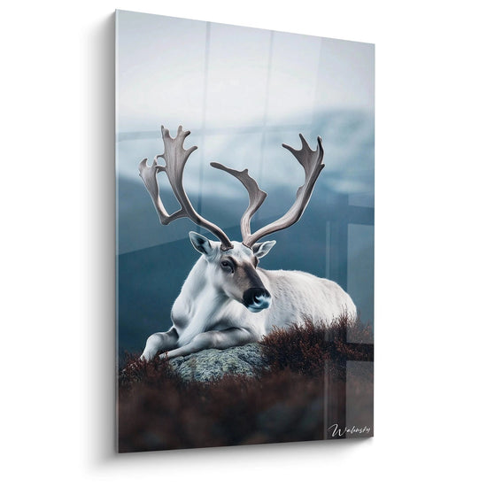 Un tableau artistique abstrait présentant un caribou blanc majestueux reposant sur un rocher, avec d'imposants bois ramifiés, entouré de végétation brune sur fond de montagnes brumeuses aux teintes bleutées.
